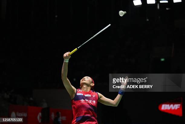 Tai Tzu Ying of Taiwan hits a return against Pusarla V. Sindhu of India during their women's singles at Indonesia Open Badminton tournament in...