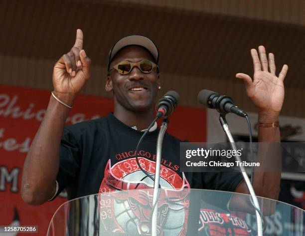 Michael Jordan holds up six fingers for each Chicago Bulls championship as he addresses the crowd at the Petrillo Music Shell at Grant Park on June...