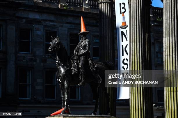 Photograph taken on June 15, 2023 shows the Wellington statue with a traffic cone on its head at the entrance of The Gallery Of Modern Art , in...