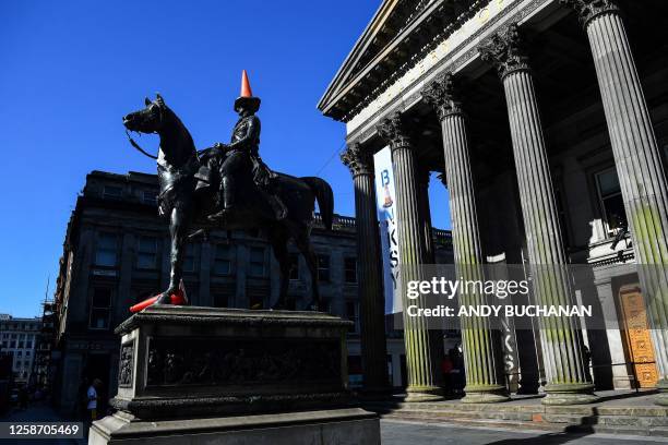 Photograph taken on June 15, 2023 shows the Wellington statue with a traffic cone on its head at the entrance of The Gallery Of Modern Art , in...