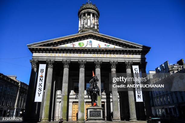 Photograph taken on June 15, 2023 shows the Wellington statue with a traffic cone on its head at the entrance of The Gallery Of Modern Art , in...