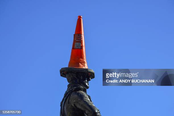 Photograph taken on June 15, 2023 shows the Wellington statue with a traffic cone on its head at the entrance of The Gallery Of Modern Art , in...