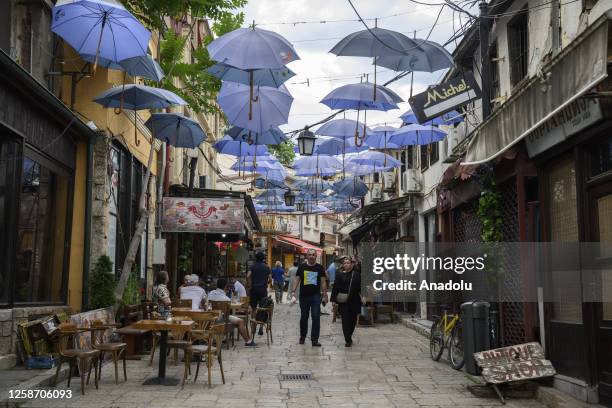 People walk between shops lined up on both sides of the street at the Skopje Turkish Bazaar, one of the busiest spots in the city center, in Skopje,...