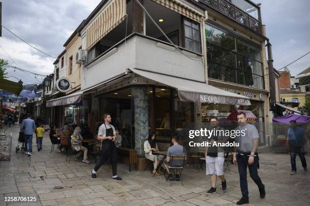 People walk between shops lined up on both sides of the street at the Skopje Turkish Bazaar, one of the busiest spots in the city center, in Skopje,...