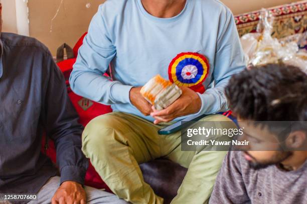 Kashmiri Muslim man holds the Mehar money, dowry to be given to kashmir Muslim bride during the Mass wedding of the down trodden section of the...