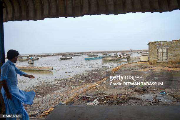 Villager stands along the Arabian Sea's coast, at the Zero Point in Badin district, Sindh province on June 15, 2023. Howling gales and crashing waves...