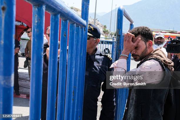 Mahmoud, an Egyptian migrant now living in Italy arrives to find information on the 10 people he knew on the boat outside of the hangar where...