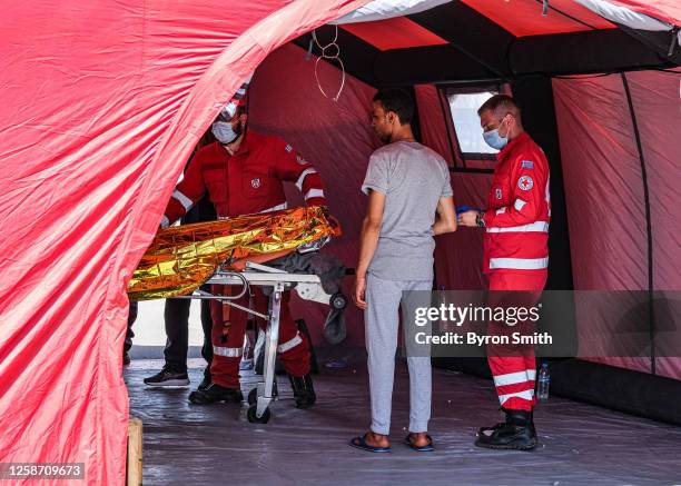 Migrant who survived the capsized boat receives medical care June 15, 2023 in Kalamata, Greece. A fishing boat carrying hundreds of passengers...