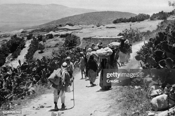 Picture released 15 September 1948 shows Arab Palestinians refugees returning to their village after its surrender during the 1948 Arab war against...