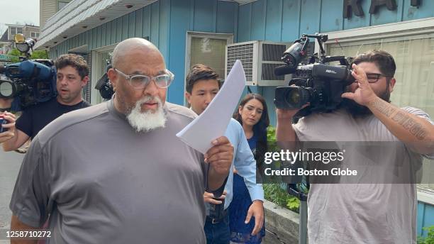 Concord, NH Former Harvard Medical School morgue manager Cedric Lodge shields his face with a printout of the indictment against him as he walked...