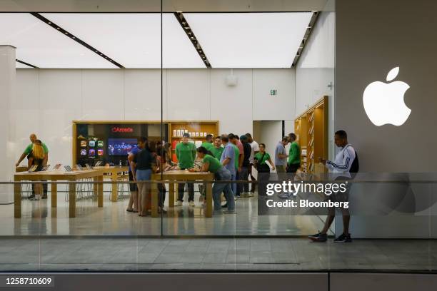 Customers at an Apple store at Brickell City Centre in Miami, Florida, US, on Wednesday, June 14, 2023. US retail sales unexpectedly rose in May,...