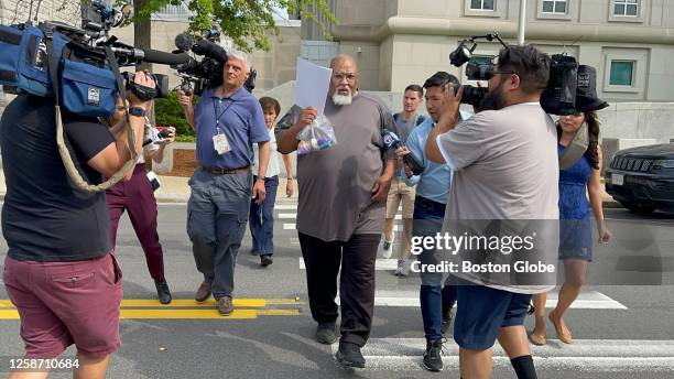 Concord, NH Former Harvard Medical School morgue manager Cedric Lodge shields his face with a printout of the indictment against him as he walked...