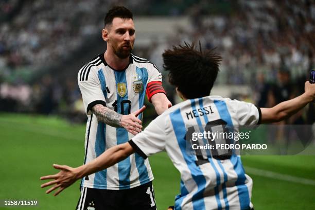 Fan runs towards Argentina's Lionel Messi during a friendly football match between Australia and Argentina at the Workers' Stadium in Beijing on June...