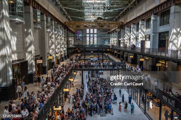 People queue to enter a new Apple Store in Battersea Power station on June 15, 2023 in London, England. Apple Battersea will be Britain's 40th store...