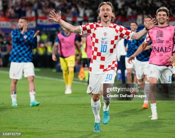 Luka Modric of Croatia celebrates Bruno Petkovic's goal with the players' bench, but the goal is eventually disallowed by VAR for offside after the...