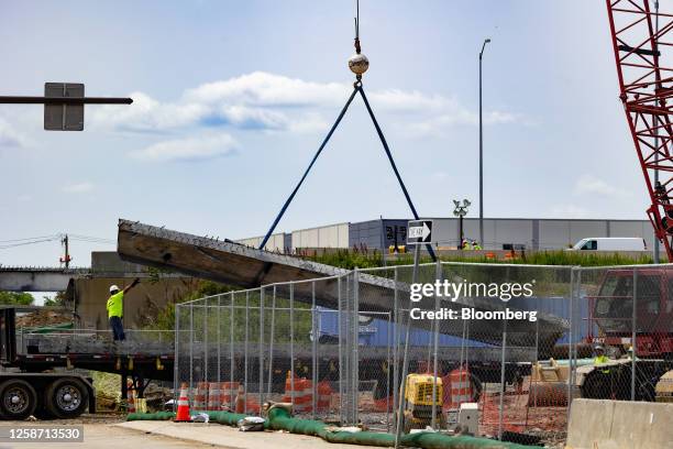 Workers inspect and clear debris from a section of the bridge that collapsed on Interstate 95 in Philadelphia, Pennsylvania, US, on Thursday, June...