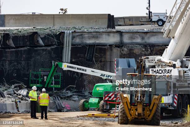 Workers inspect and clear debris from a section of the bridge that collapsed on Interstate 95 in Philadelphia, Pennsylvania, US, on Thursday, June...