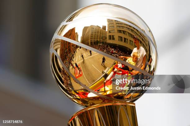 Nikola Jokic is reflected in the Larry O'Brien Championship Trophy during the Denver Nuggets victory parade and rally after winning the 2023 NBA...
