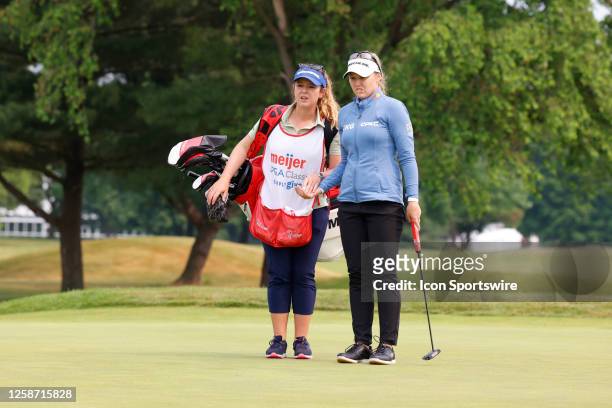 Golfer Brooke Henderson talks to her sister and caddie Brittany Henderson on the 2nd hole on June 15 during the LPGA Meijer LPGA Meijer Classic for...