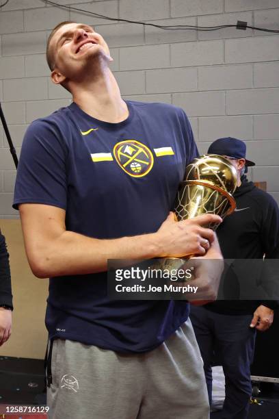 Nikola Jokic of the Denver Nuggets celebrates with the Bill Russell MVP trophy after winning Game Five of the 2023 NBA Finals on June 12, 2023 at...
