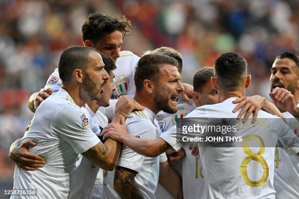 Italy's forward Ciro Immobile celebrates scoring his team's first goal with teammates after a penalty kick during the UEFA Nations League semi final...