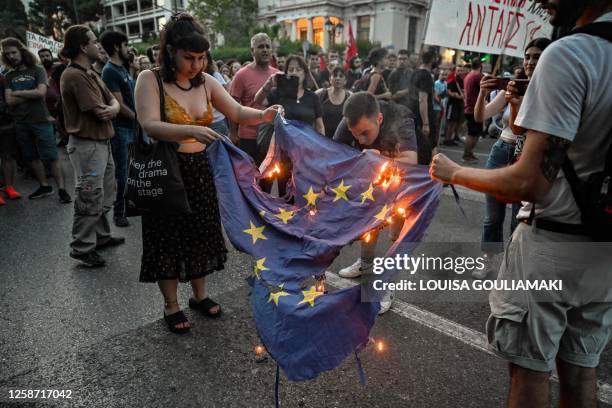 Protesters burn an EU flag in front of the EU offices during a demonstration following a deadly shipwreck which costed lives of at least 78 migrants...