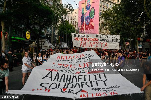 Protesters hold a banner that reads "EU policies kill" during a demonstration to protest against the EU and Greek government's policies following a...
