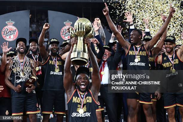 Monaco's French guard Yakuba Ouattara raises the French Elite trophy as Monaco players celebrate after winning the game three of French Elite...