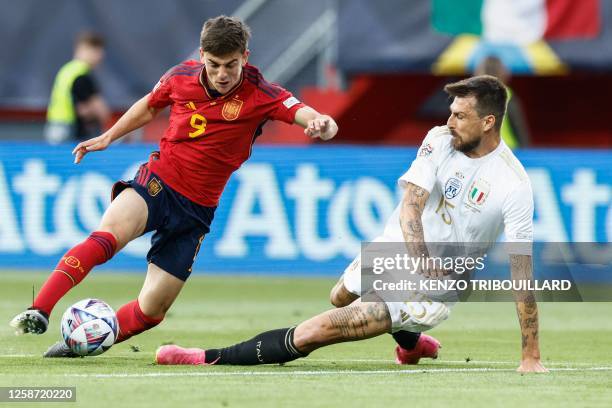 Spain's midfielder Gavi fights for the ball with Italy's defender Francesco Acerbi during the UEFA Nations League semi final football match between...