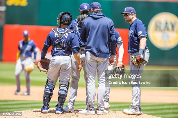 Tampa Bay Rays Pitcher Taj Bradley has a conference at the mound during the Major League Baseball game between the Tampa Bay Rays and the Oakland...