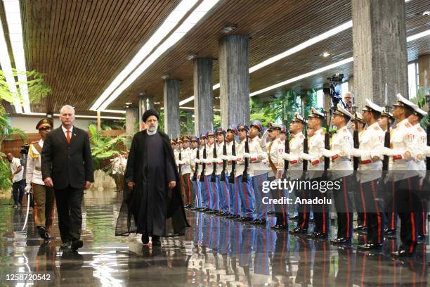 Iranian President Ebrahim Raisi and Cuban President Miguel Mario Diaz-Canel Bermudez walk past the honor guards during an official ceremony in...