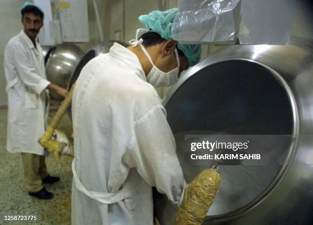 Iraqis works on the production line of medicine for chronic diseases at the Samarra drug plant, 120km north of Baghdad, 23 June 2001. Baghdad accused...