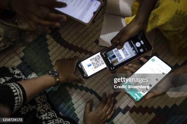 Participants scan a QR code at the Jugalbandi bot field trial in Bengaluru, India, on Wednesday, April 19, 2023. The AI trial is aimed at helping...