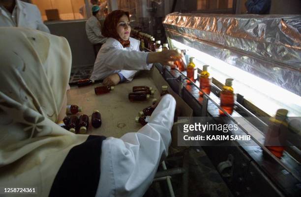 Iraqi women work on the production line of medicine for chronic diseases at the Samarra drug plant,120km north of Baghdad, 23 June 2001. Baghdad...