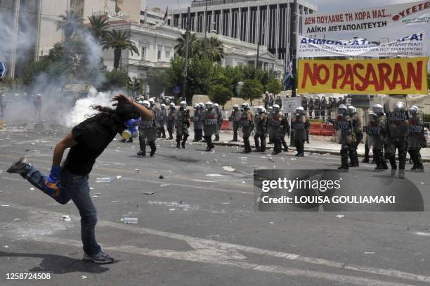 Demonstrators face riot police outside the Greek Parliament on June 29, 2011 in Athens during a 48-hour general strike. Protestors clashed with...
