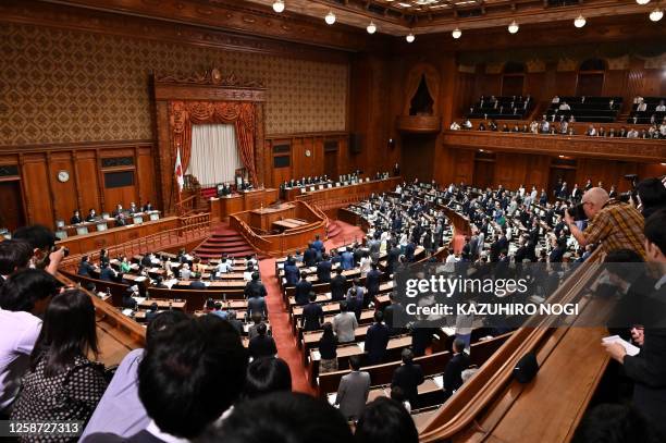 Members of the House of Councilors vote on a bill to secure financial resources to increase defense spending at the plenary session of the House of...