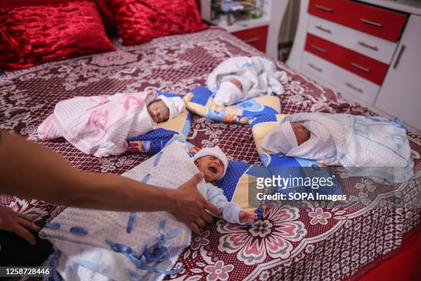 Quadruplets are seen lying on the bed. Gaza city resident, 38-year-old Rasmiya, gave birth to quadruplets, three males and one female, which were...