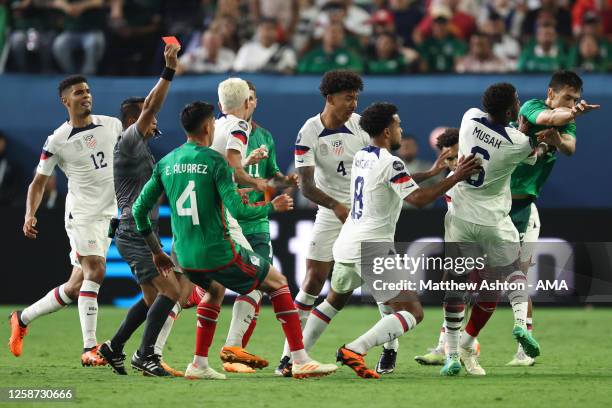 Cesar Montes of Mexico clashes with Yunus Musah of USA as Referee Ivan Barton from El Salvador shows his a red card during the CONCACAF Nations...