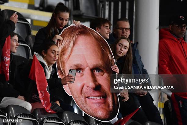 Crusaders' fans hold a photo of team coach Scott Robertson and take selfies during the Super Rugby Pacific Semi Final match between Crusaders and...