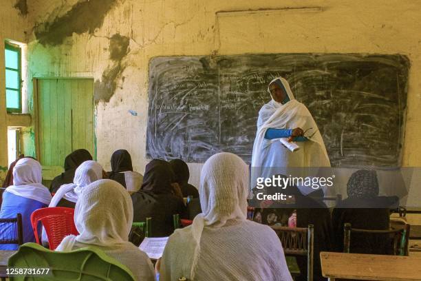 Picture taken on June 15 shows students attending a lesson at a secondary school for girls in Wad Madani, the capital of Sudan's al-Jazirah state,...