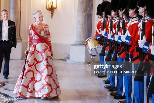 Denmark's Queen Margrethe II inspects the Guard of Honour ahead of the dinner at Amalienborg Castle in Copenhagen, on June 15 during an offical visit...