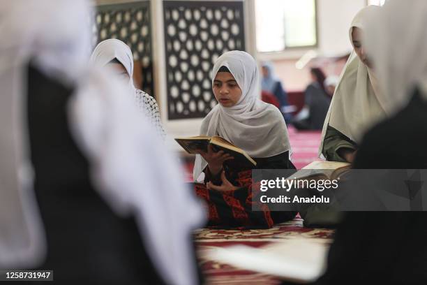 Young girl studies during Quran courses starting with the beginning of summer holiday at al-Taqwa Mosque in Gaza City, Gaza on June 14, 2023.