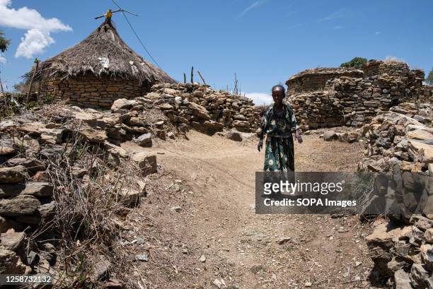 Woman from a small village near the town of Samre walks near her home. Tigray, one of the bloodiest wars of the 21st century, has left at least...