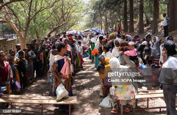 Dozens of women and children queue inside the Don Bosco humanitarian aid center in Tigray to receive soup to treat child malnutrition. Tigray, one of...