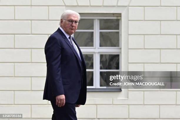 German President Frank-Walter Steinmeier grimaces as he waits to greet the Colombian President ahead of a welcoming ceremony at the presidential...