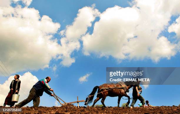 Ethnic Albanians work in their land, 26 April 2006 as the Prime Minister Agim Çeku visited the border village of Debelde in the verge of his first...