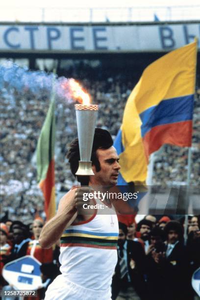 Olympic torchbearer runs with the Olympic torch during the opening ceremony of the Moscow 1980 Summer Olympic Games, at the Lenin Central Stadium in...