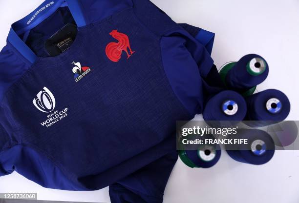 This photograph taken on June 16, 2023 shows the French team's jersey for the 2023 rugby union World Cup displayed at the production line of French...