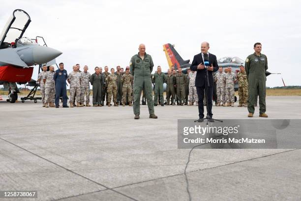German Chancellor Olaf Scholz speaks to the media as he stands in front of a German Tornado fighter plane during a visit to the Air Defender 2023...