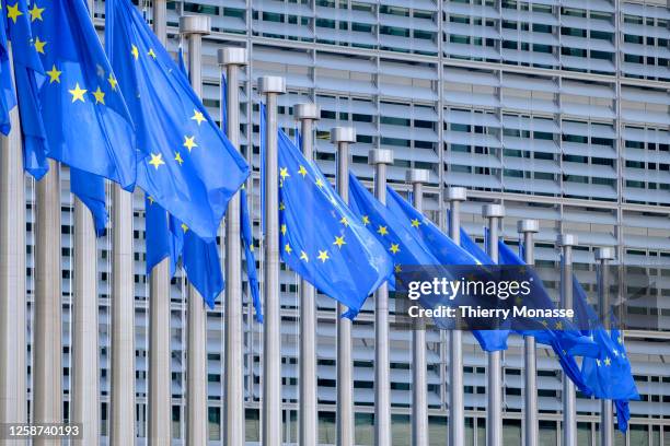 The EU flags flutter in the wind in front of the Berlaymont, the EU Commission headquarter on June 16, 2023 in Brussels, Belgium. The Flag of Europe,...